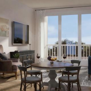 A modern living and dining area with large windows offering a scenic view.