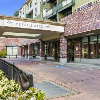 The entrance to Merrill Gardens with its welcoming architecture and landscaped surroundings.