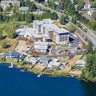 Aerial view of a waterfront residential area with buildings near a lake.