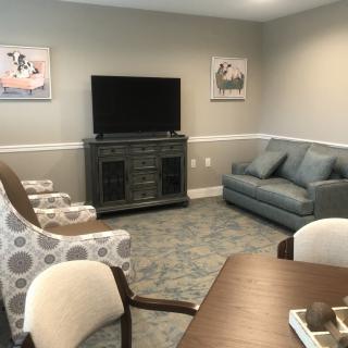 A cozy living room with comfortable seating arrangements and a television.