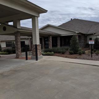 A view of a residential building with landscaped surroundings.