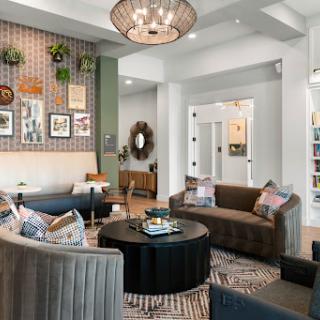 A contemporary living room featuring stylish furniture, decorative artwork, and a warm, inviting ambiance.