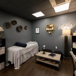 A cozy massage room with soft lighting and elegant decor, perfect for relaxation and therapy.
