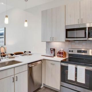 A modern kitchen with stainless steel appliances and sleek cabinetry.