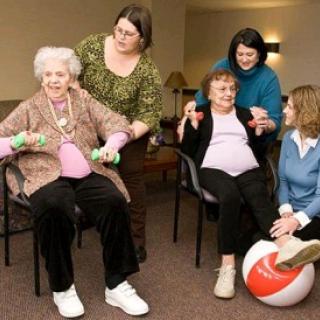 A group of seniors engaged in a fun and supportive exercise session, promoting health and well-being.