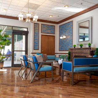 A stylish indoor seating area featuring modern furniture and a warm color palette.