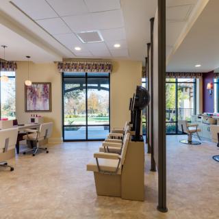 A modern office reception area with natural lighting and stylish furnishings.