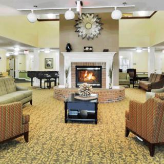 A cozy living room with a fireplace and comfortable seating.