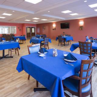 A spacious and inviting dining area with blue tables ready for guests.