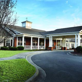 A welcoming residential building with a spacious driveway and well-maintained landscaping.