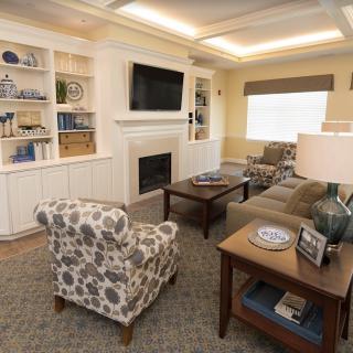 A cozy living room with a fireplace, TV, and stylish furniture.