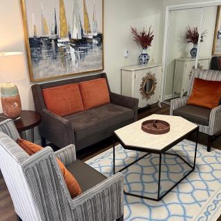 A cozy living room with modern furniture and colorful decor.