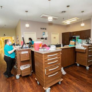 A view of a busy medical office reception area with staff attending to tasks.