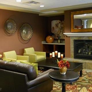A modern living room with comfortable seating and a cozy fireplace.