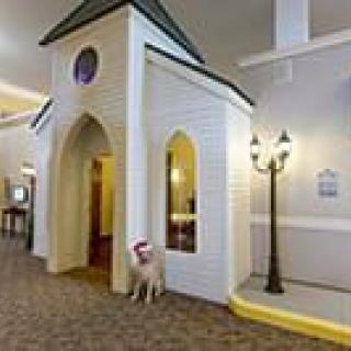 A unique hotel interior featuring a chapel structure with a dog statue at the entrance.