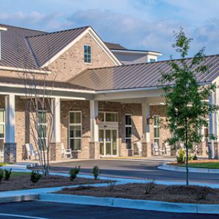 A modern building with a welcoming entrance and well-maintained landscaping.