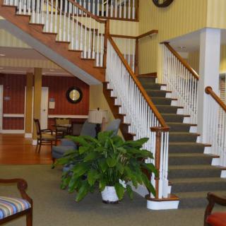 A welcoming lobby area with a staircase and comfortable seating.