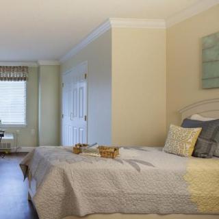 A cozy bedroom with soft colors and ample natural light.