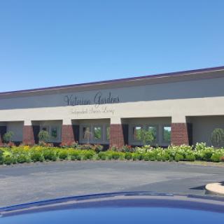 A view of a commercial building with well-maintained landscaping on a clear day.