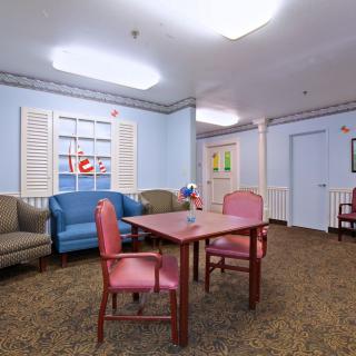 A cozy living space with colorful furniture and decor.