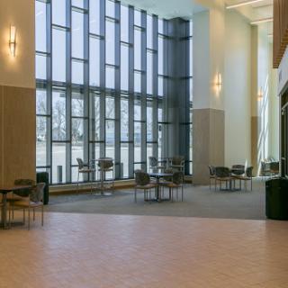 A bright and spacious contemporary lobby with large windows and minimalistic furniture.
