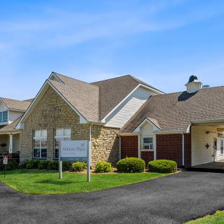 A suburban residential house with a well-maintained lawn and driveway.