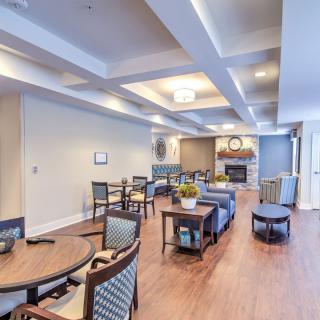 A spacious and modern living area featuring comfortable seating, a fireplace, and stylish decor.
