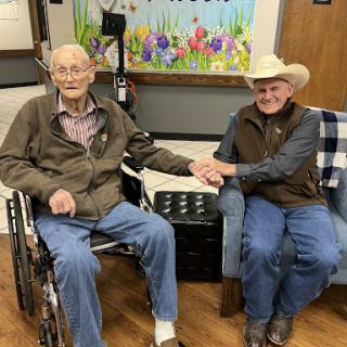 Two friends sharing a moment together in an assisted living facility.