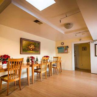 A cozy dining area with wooden furniture and decorative elements.