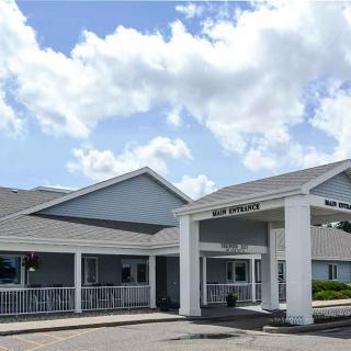 A building with a welcoming entrance under a partly cloudy sky.