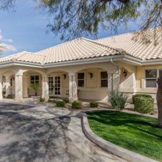 A single-story house with a tiled roof and well-maintained landscaping.