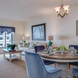 A cozy living and dining area with elegant furniture and tasteful decor.