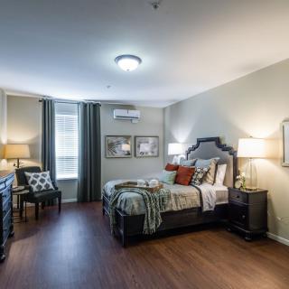 A modern and comfortable bedroom with stylish decor and ample natural lighting.