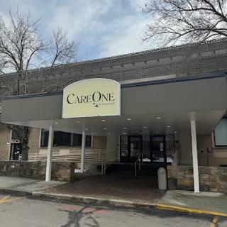 Entrance of a building with the sign 'Caf One' prominently displayed.