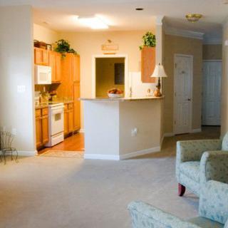 An open floor plan apartment with a cozy kitchen and living room area.
