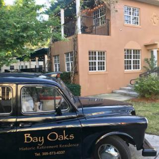 A classic taxi in front of a charming building, showcasing local character.
