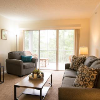 A cozy living room with comfortable seating and natural lighting.