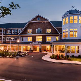 A well-lit hotel exterior during the evening.