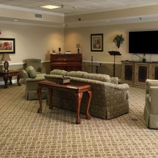 A spacious living room with comfortable seating and a large television.