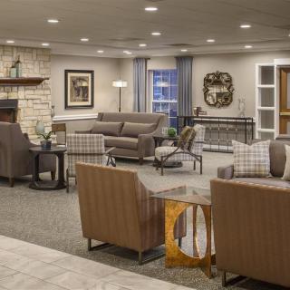 A cozy and well-furnished living room with sofas, chairs, and stylish decor.