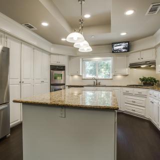 Modern kitchen with an island counter and white cabinetry.