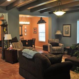 A cozy living room with comfortable seating and warm lighting.