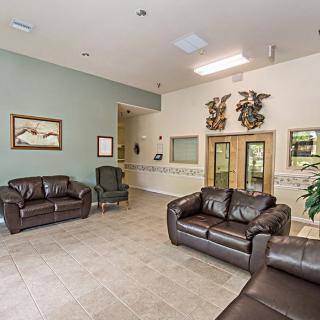 A spacious waiting room featuring leather sofas and tasteful decor.