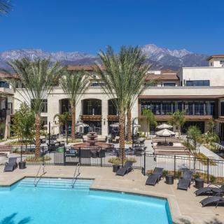 A luxurious hotel with a stunning pool area and scenic mountain views.