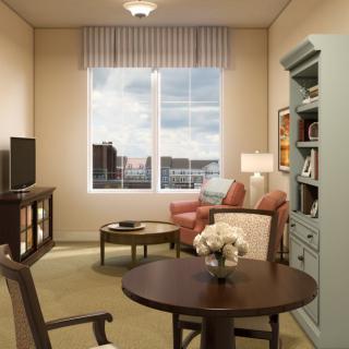 A cozy living room with comfortable seating and a large window offering a view of the outdoors.