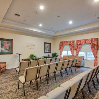 A neatly arranged meeting room with rows of chairs and decorative elements.