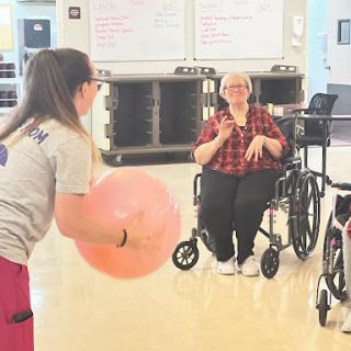 Engaging in a fun rehabilitation activity with a large exercise ball.