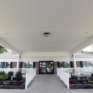 Front entrance of a building with ramps and landscaping.