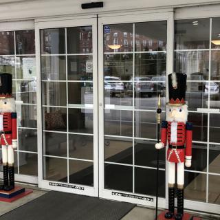 Nutcracker figures standing guard at the entrance of a store.