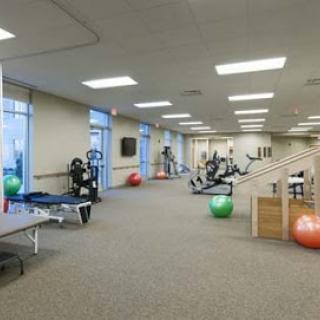 A well-equipped gym designed for fitness and rehabilitation activities.